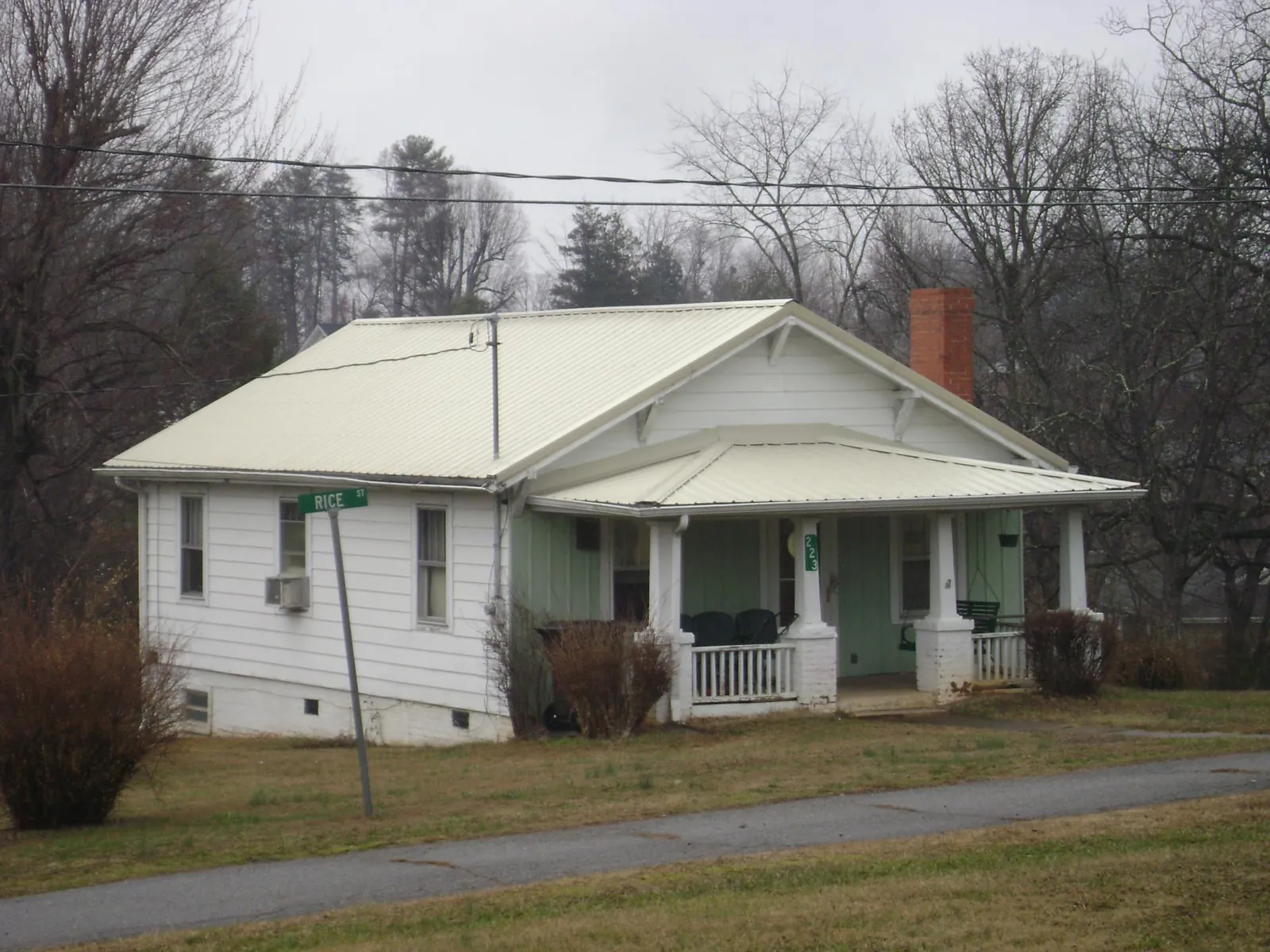 White metal roof on a craftsman bungalow at a street corner in Strawberry Plains